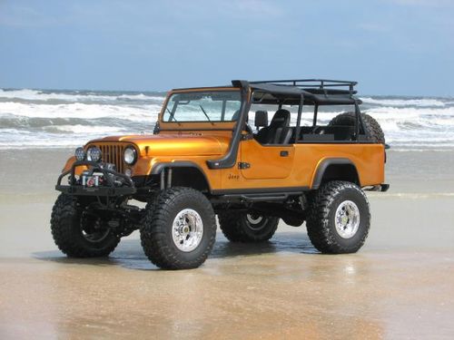 Gold Jeep on the beach